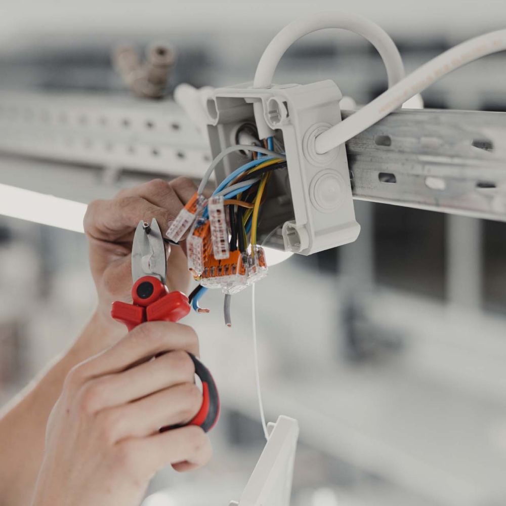 Electrical Expertise in Action, Junction Wiring Installation with Skilled Hands in Close-up view