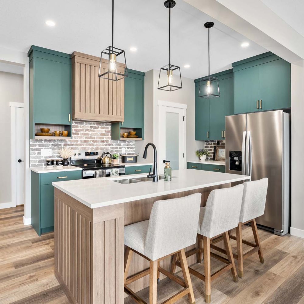 Kitchen with a white island and blue cabinets. The kitchen has a modern feel with a lot of light and a lot of white